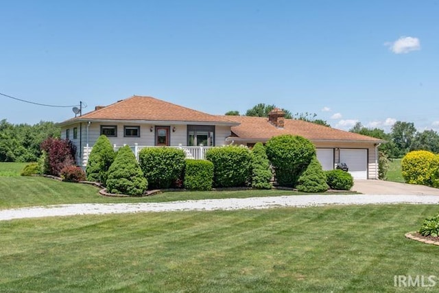 view of front of house featuring a garage and a front yard