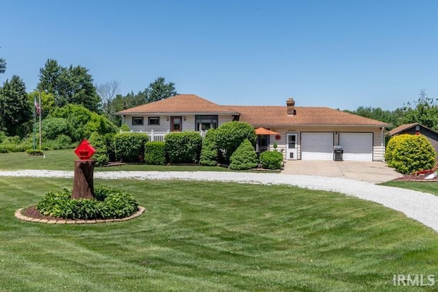 view of front facade with a garage and a front yard