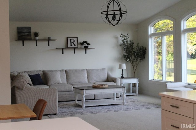 living room featuring light colored carpet and a notable chandelier