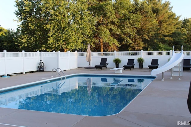 view of pool featuring a patio and a water slide