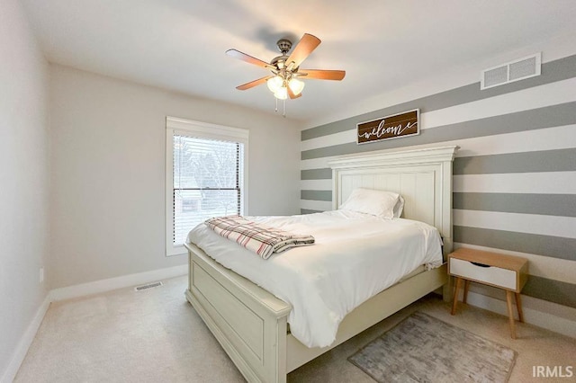 bedroom featuring visible vents, ceiling fan, light carpet, and baseboards