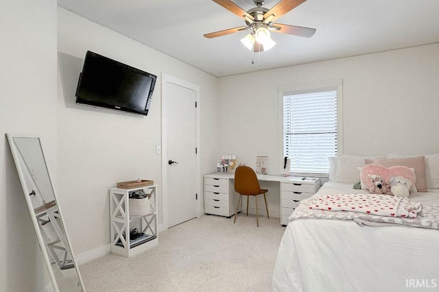 bedroom with ceiling fan, baseboards, and light colored carpet