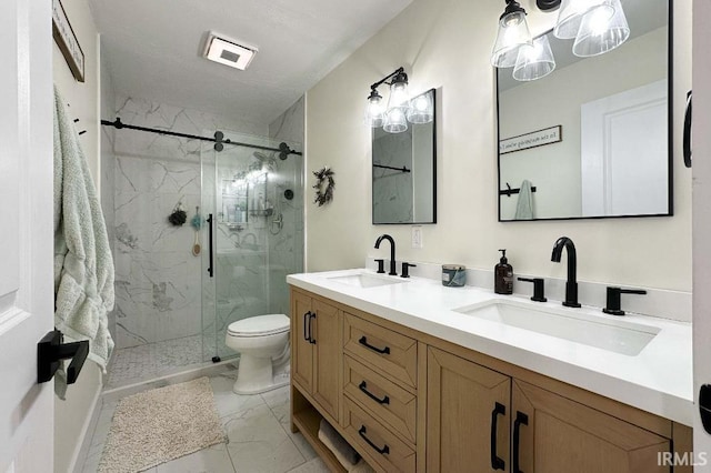 full bathroom with marble finish floor, double vanity, a sink, and a marble finish shower