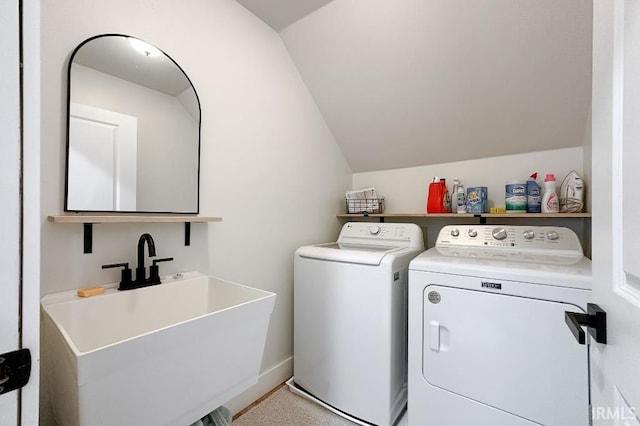 laundry area with laundry area, washer and clothes dryer, and a sink