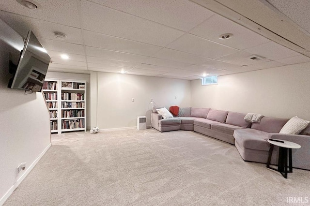 living room with carpet flooring, visible vents, baseboards, and a drop ceiling