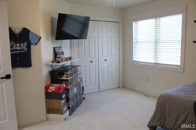 carpeted bedroom featuring a closet