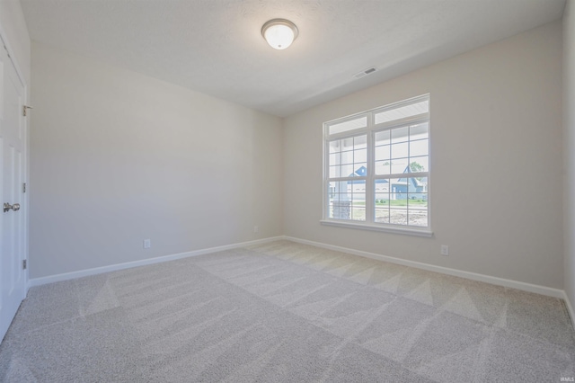 unfurnished room with light carpet