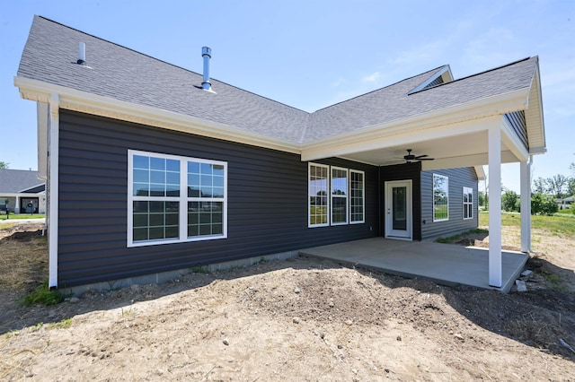 back of property with ceiling fan and a patio