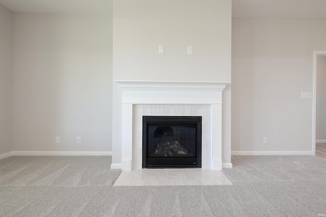 room details with a tile fireplace and carpet floors