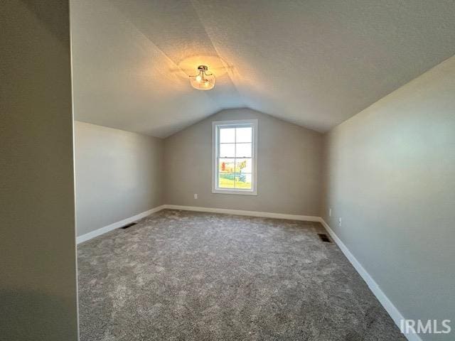 bonus room featuring lofted ceiling and carpet floors