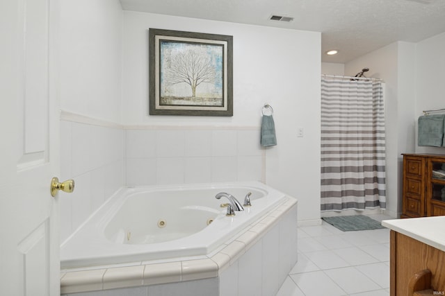 bathroom with tile patterned flooring, vanity, independent shower and bath, and a textured ceiling