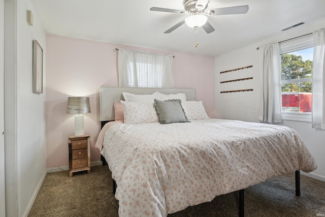 bedroom with ceiling fan and dark colored carpet