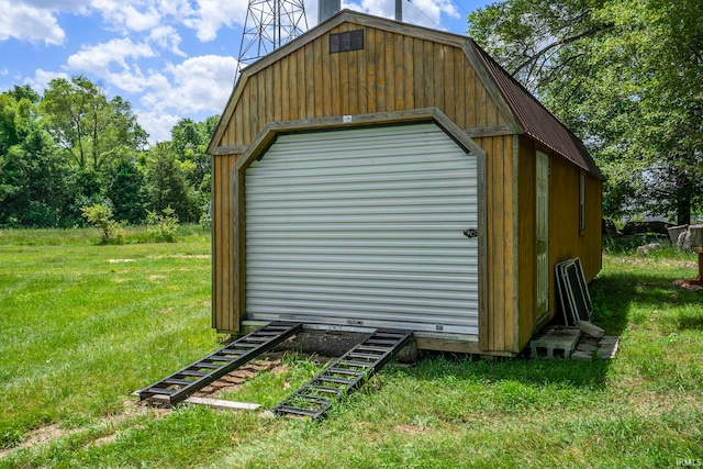 view of outdoor structure featuring a lawn