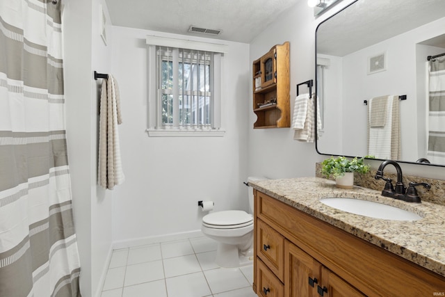 bathroom featuring vanity, toilet, and tile patterned flooring