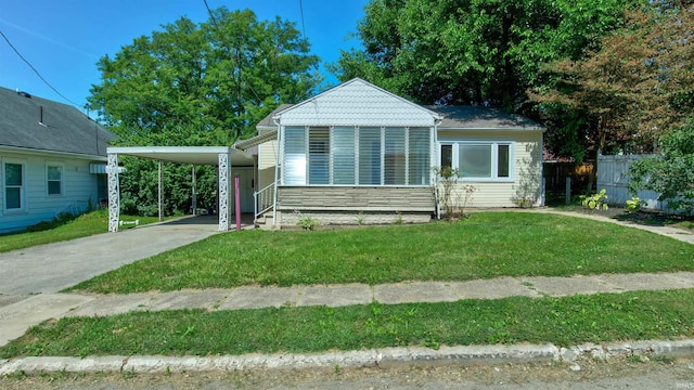 bungalow-style house featuring a front yard and a carport