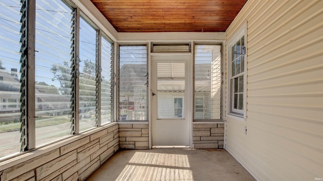 unfurnished sunroom with wood ceiling