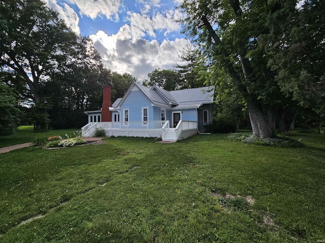 view of side of home with a yard and a wooden deck