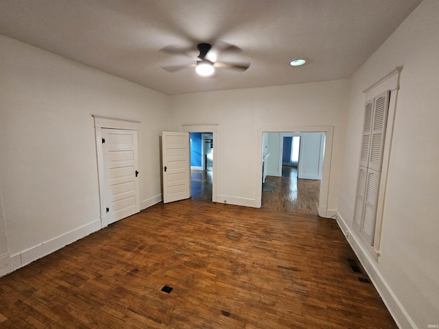 unfurnished bedroom with ceiling fan and dark hardwood / wood-style flooring