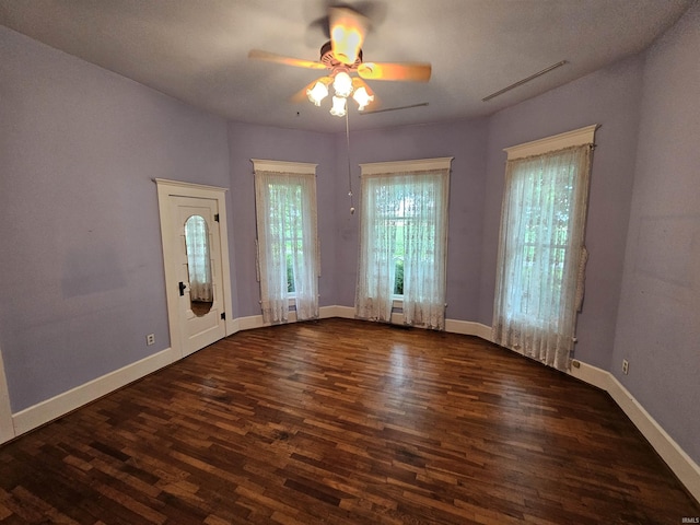 interior space with dark hardwood / wood-style flooring and ceiling fan