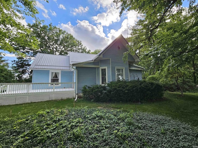 view of front of property with a wooden deck and a front yard