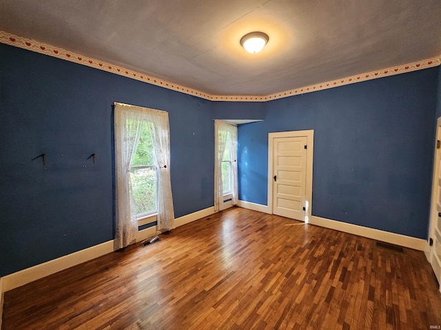 unfurnished room with wood-type flooring