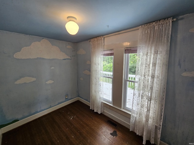 unfurnished room with dark wood-type flooring