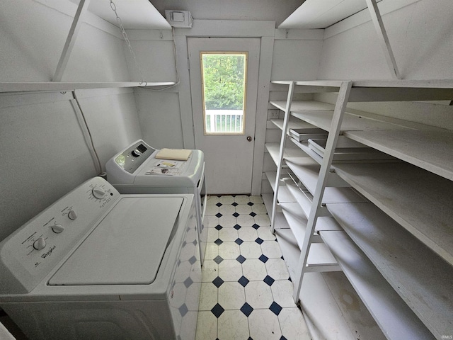 clothes washing area with washing machine and clothes dryer