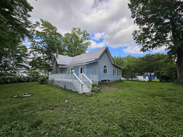 view of side of property featuring a wooden deck and a yard