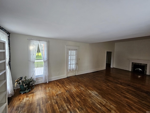 unfurnished living room featuring dark wood-type flooring