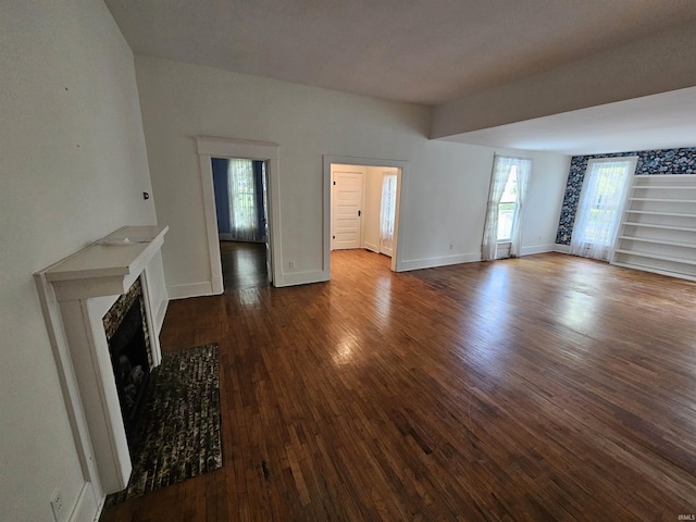 unfurnished living room featuring hardwood / wood-style floors and a healthy amount of sunlight