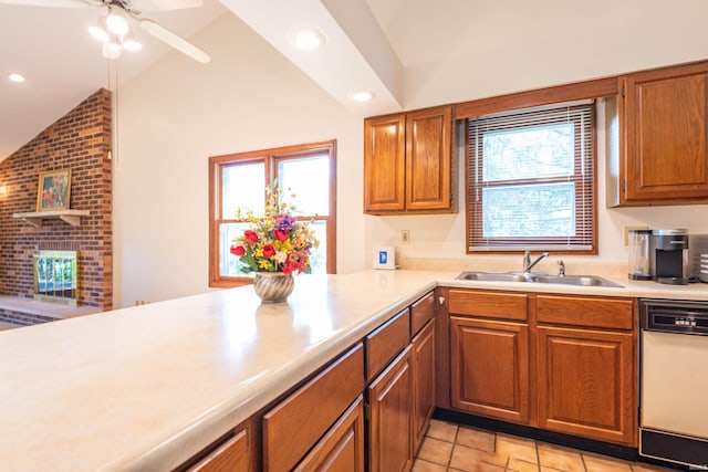 kitchen with ceiling fan, light tile flooring, white dishwasher, sink, and lofted ceiling