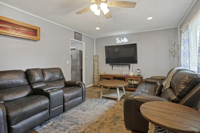 carpeted living room with ceiling fan, ornamental molding, and a textured ceiling