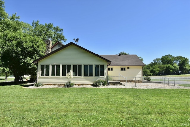 back of house featuring a yard