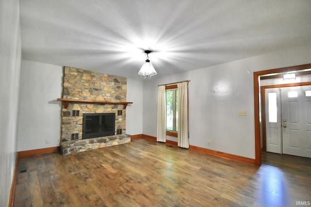 unfurnished living room featuring dark hardwood / wood-style flooring and a fireplace