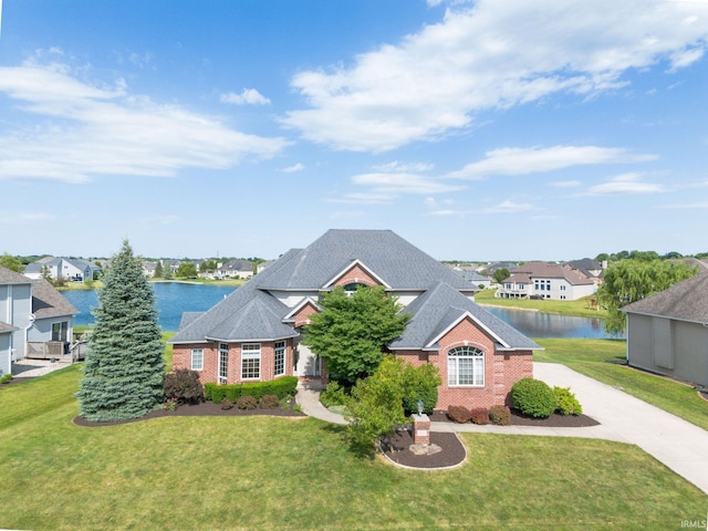 view of front of house featuring a front yard and a water view