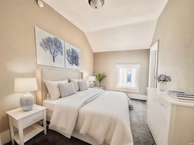 carpeted bedroom with lofted ceiling