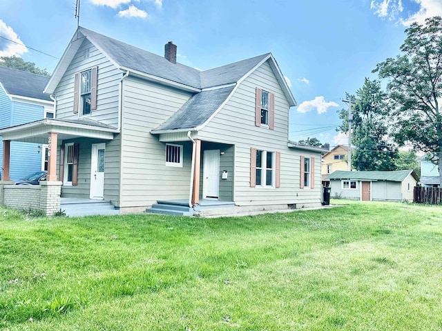 front facade with covered porch and a front yard