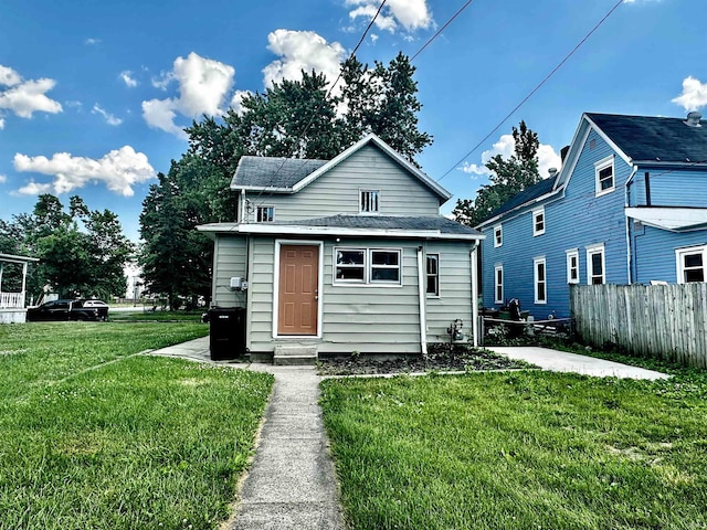 rear view of property with a yard