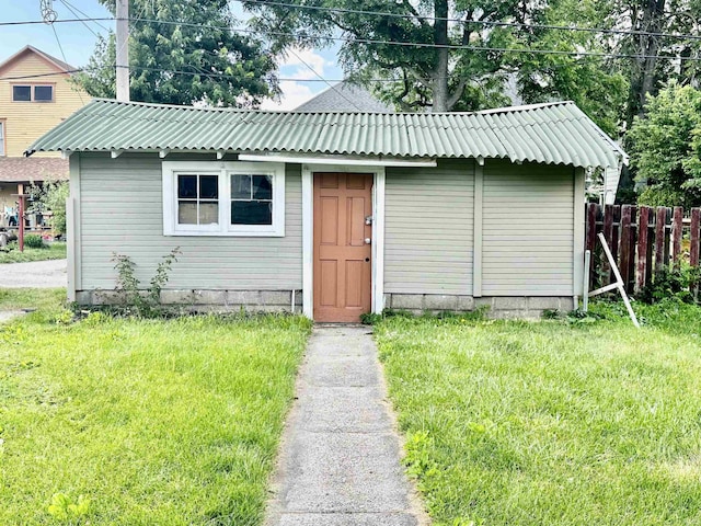 view of outbuilding featuring a lawn