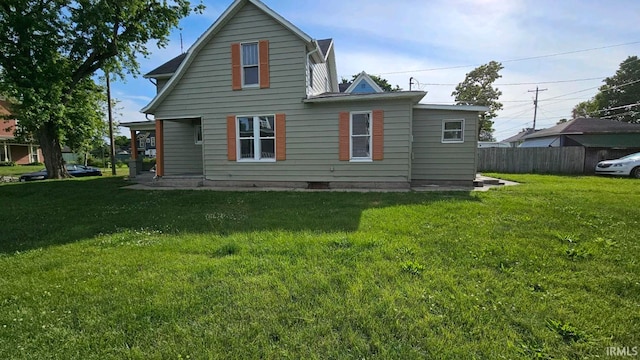 back of property featuring a lawn