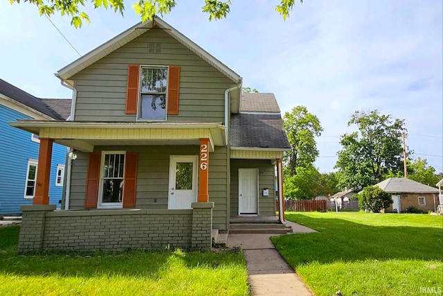 view of front of house with covered porch and a front lawn