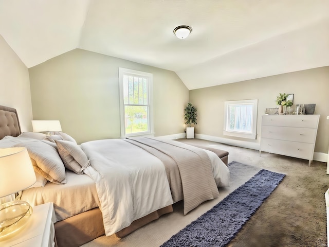 carpeted bedroom with vaulted ceiling