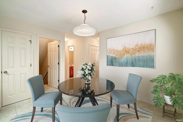 dining space with light tile patterned floors and baseboards