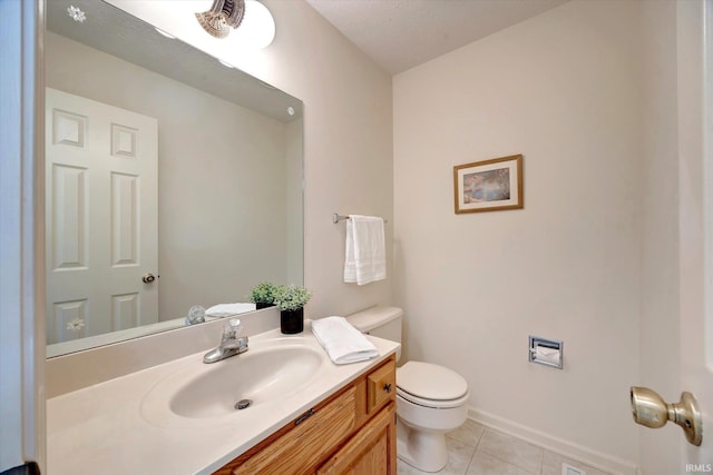 bathroom with vanity, tile patterned flooring, toilet, and baseboards