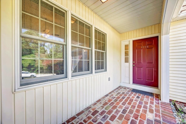 view of exterior entry featuring covered porch