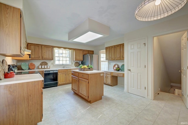 kitchen with under cabinet range hood, appliances with stainless steel finishes, light countertops, and a center island