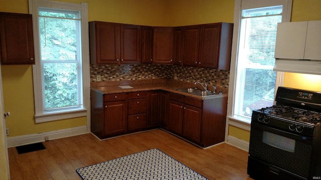 kitchen featuring sink, black range with gas cooktop, and a wealth of natural light