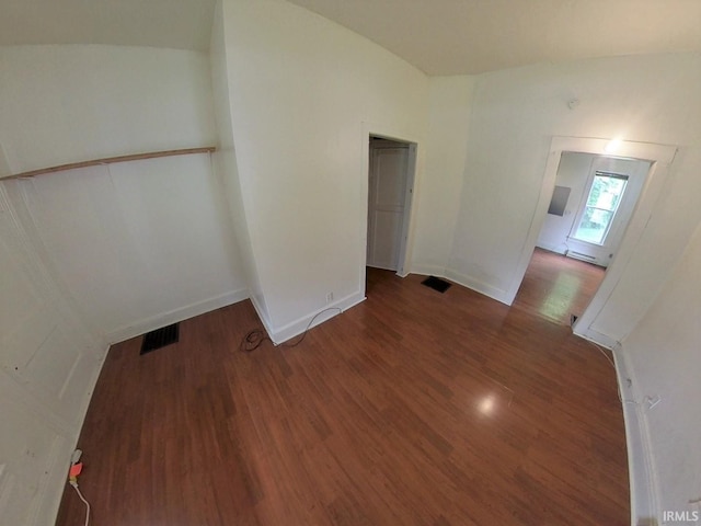 spare room with dark hardwood / wood-style flooring and baseboard heating