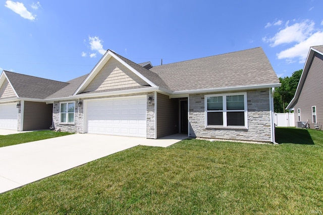 view of front of property with a front yard and a garage