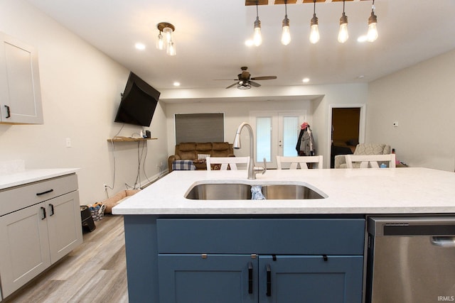 kitchen with ceiling fan, sink, pendant lighting, a center island with sink, and dishwasher